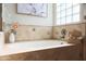 Relaxing bathroom with soaking tub and tile surround at 11553 N 76Th Dr, Peoria, AZ 85345