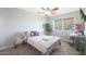 Cozy bedroom with window, ceiling fan, and a comfy bed at 11553 N 76Th Dr, Peoria, AZ 85345