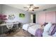 Bedroom with desk, ceiling fan, and pink closet doors at 11553 N 76Th Dr, Peoria, AZ 85345