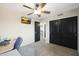 Bedroom with ceiling fan, double doors, and large closet at 11553 N 76Th Dr, Peoria, AZ 85345