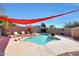 Relaxing pool area with a red shade sail and comfortable seating at 11553 N 76Th Dr, Peoria, AZ 85345