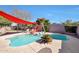 Inviting kidney shaped pool with red shade sail at 11553 N 76Th Dr, Peoria, AZ 85345