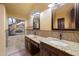 Bathroom boasts double vanity, granite countertops, and large mirror at 1157 E Liberty Ln, Gilbert, AZ 85296