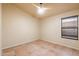 Well-lit bedroom featuring tile floors and a ceiling fan at 1157 E Liberty Ln, Gilbert, AZ 85296