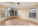 Sun-drenched living room with arched windows and tile floors at 1157 E Liberty Ln, Gilbert, AZ 85296