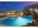 Stunning pool and spa at dusk with outdoor kitchen at 1157 E Liberty Ln, Gilbert, AZ 85296