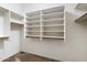 Spacious walk-in closet with ample shelving and hanging rods at 1157 E Liberty Ln, Gilbert, AZ 85296