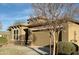 Charming home exterior featuring a well-maintained lawn and a two-car garage, creating curb appeal at 12075 E Chevelon Trl, Gold Canyon, AZ 85118