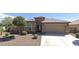 House with a tile roof, two-car garage, and front yard landscaping at 12075 E Chevelon Trl, Gold Canyon, AZ 85118