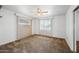 Bright bedroom with ceiling fan and window coverings at 1231 E Vine Ave, Mesa, AZ 85204