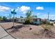 Ranch style home with a flat roof and desert landscaping at 1231 E Vine Ave, Mesa, AZ 85204