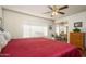 King-size bed in a well-lit Primary bedroom with ensuite access at 12323 W Tigerseye Dr, Sun City West, AZ 85375