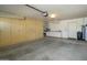 Garage with built-in cabinets and storage shelving at 12323 W Tigerseye Dr, Sun City West, AZ 85375