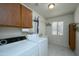 Laundry room with washer, dryer, and storage cabinets at 12323 W Tigerseye Dr, Sun City West, AZ 85375