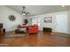 Living room features hardwood floors and orange couches at 12323 W Tigerseye Dr, Sun City West, AZ 85375