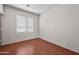 Well-lit bedroom with window and wood-look flooring at 12930 W Pershing St, El Mirage, AZ 85335