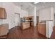 Kitchen with island, wood cabinets, and modern appliances at 12930 W Pershing St, El Mirage, AZ 85335