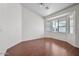 Light-filled living room with large bay window and hardwood floors at 12930 W Pershing St, El Mirage, AZ 85335