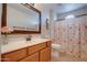 Bathroom with a single vanity and floral shower curtain at 1397 E Cheyenne St, Gilbert, AZ 85296