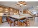 Wet bar with wooden cabinets and seating for four at 1397 E Cheyenne St, Gilbert, AZ 85296