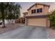 Two-story house with attached garage and a front porch swing at 1540 W Orchid Ln, Chandler, AZ 85224