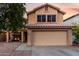 Two-story house with attached garage and charming front porch swing at 1540 W Orchid Ln, Chandler, AZ 85224