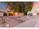 Charming two-story home featuring a cozy front porch swing, desert landscaping, and a two-car garage at 1540 W Orchid Ln, Chandler, AZ 85224