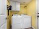 Laundry room with washer, dryer, and ample cabinet space at 1540 W Orchid Ln, Chandler, AZ 85224