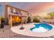 Spacious backyard with a pool, patio dining set, second story deck, and well-kept landscaping at 1540 W Orchid Ln, Chandler, AZ 85224