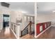 Upstairs hallway with wood flooring and a red accent wall at 1540 W Orchid Ln, Chandler, AZ 85224