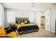 Main bedroom with king-size bed, yellow accents, and en-suite bathroom at 15541 S 181St Ln, Goodyear, AZ 85338