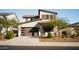 Two-story home with brown garage door and landscaped yard at 15541 S 181St Ln, Goodyear, AZ 85338