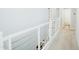 Upstairs hallway with white railing and carpeted floor at 15541 S 181St Ln, Goodyear, AZ 85338