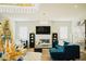 Elegant living room with sectional sofa, fireplace, and large TV at 15541 S 181St Ln, Goodyear, AZ 85338