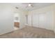 Well-lit bedroom featuring plush carpeting and double doors at 16614 N 51St St, Scottsdale, AZ 85254