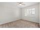 Well-lit bedroom featuring carpet, ceiling fan, and window coverings at 16614 N 51St St, Scottsdale, AZ 85254