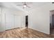 Bedroom with wood-look floors, double doors to closet, and access to bathroom at 16614 N 51St St, Scottsdale, AZ 85254