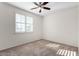 Spacious bedroom with ceiling fan and large window at 16614 N 51St St, Scottsdale, AZ 85254