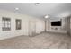 Large bonus room with built-in shelving and a media center at 16614 N 51St St, Scottsdale, AZ 85254