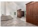 Grand entryway with tiled flooring, staircase, and built-in shelving at 16614 N 51St St, Scottsdale, AZ 85254