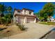 Two-story home with a large driveway, attached two-car garage, and manicured lawn at 16614 N 51St St, Scottsdale, AZ 85254