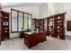 Bright home office with ample built-in shelving and a large desk at 16614 N 51St St, Scottsdale, AZ 85254