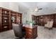 Large home office with extensive built-in shelving and a workspace at 16614 N 51St St, Scottsdale, AZ 85254