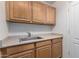 Laundry room with cabinets and a utility sink at 16614 N 51St St, Scottsdale, AZ 85254