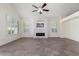 Living room with fireplace, tile floors and large windows at 16614 N 51St St, Scottsdale, AZ 85254