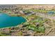 Aerial view of community with pool, lake, and putting green at 17256 W West Wind Dr, Surprise, AZ 85387