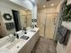 Modern bathroom with double vanity and walk-in shower at 17256 W West Wind Dr, Surprise, AZ 85387