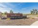 Entrance to Heritage Club community with water feature and landscaping at 17256 W West Wind Dr, Surprise, AZ 85387