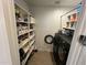 Convenient laundry room with washer, dryer and storage shelves at 17256 W West Wind Dr, Surprise, AZ 85387