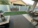 Relaxing patio with artificial turf and fire feature at 17256 W West Wind Dr, Surprise, AZ 85387